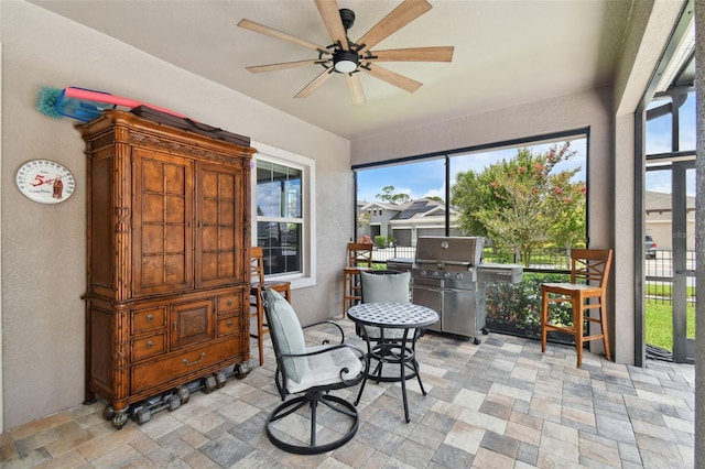 sunroom featuring ceiling fan