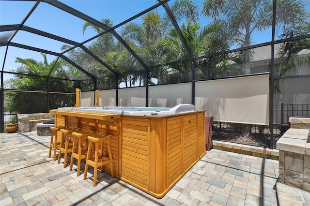 view of patio / terrace featuring exterior bar and glass enclosure