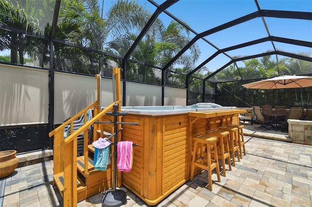 view of patio featuring an outdoor bar and glass enclosure