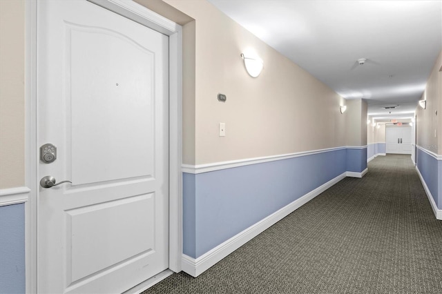 corridor with dark colored carpet