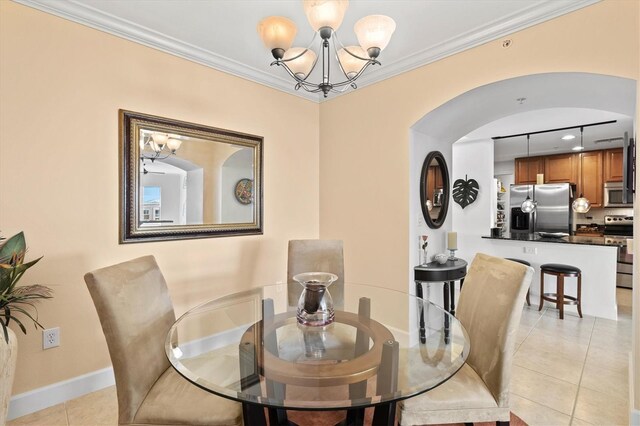 tiled dining space with an inviting chandelier and ornamental molding