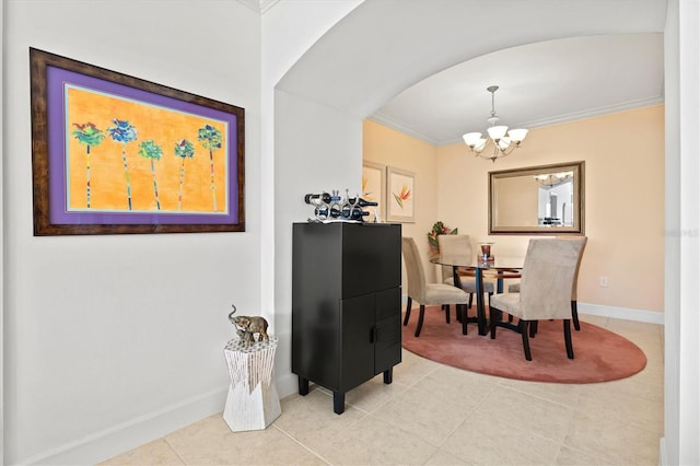 dining area with an inviting chandelier, ornamental molding, and light tile patterned floors