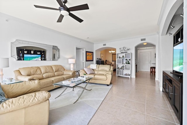 tiled living room with ornamental molding and ceiling fan