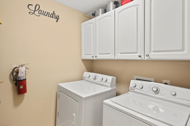 laundry area with cabinets and washing machine and clothes dryer