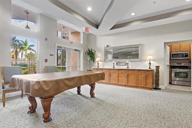 recreation room with pool table, light carpet, and a towering ceiling