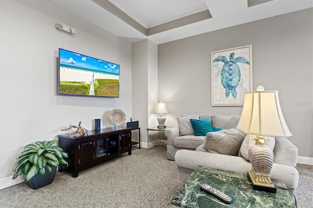 carpeted living room with ornamental molding and a raised ceiling