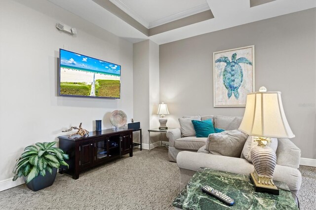 living room featuring a raised ceiling, ornamental molding, and carpet