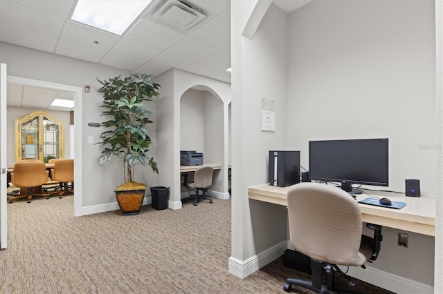 carpeted office featuring a paneled ceiling