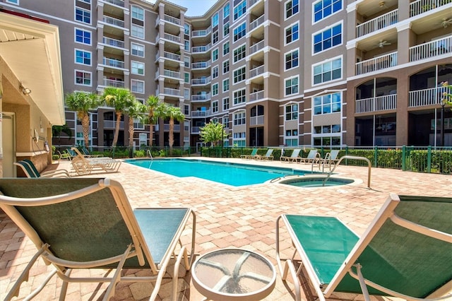 view of pool featuring a hot tub and a patio area