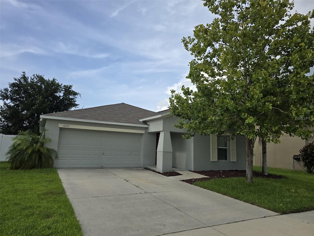 view of front of house with a garage and a front lawn