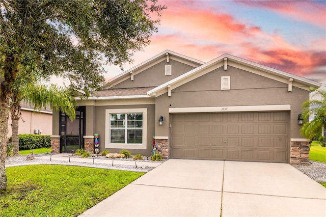 view of front of home featuring a garage and a lawn