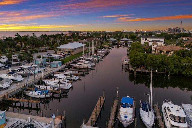 aerial view at dusk featuring a water view