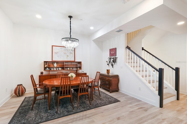 dining space featuring recessed lighting, visible vents, wood finished floors, baseboards, and stairs