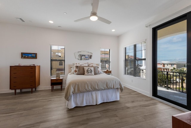 bedroom with hardwood / wood-style floors, access to exterior, and ceiling fan