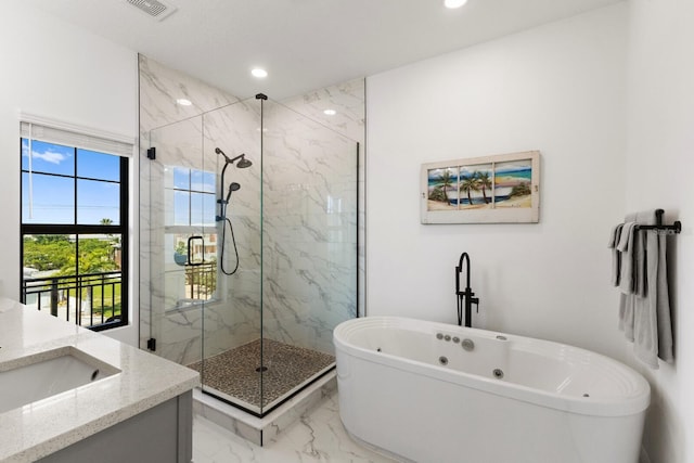 full bathroom with marble finish floor, a marble finish shower, recessed lighting, a freestanding bath, and vanity