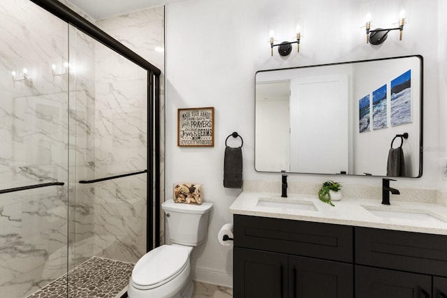 bathroom featuring marble finish floor, a marble finish shower, a sink, and toilet