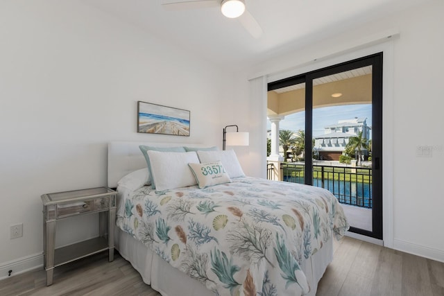 bedroom featuring a water view, ceiling fan, access to exterior, and light hardwood / wood-style floors