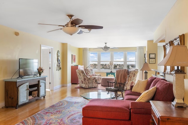 living room with light wood-type flooring and ceiling fan