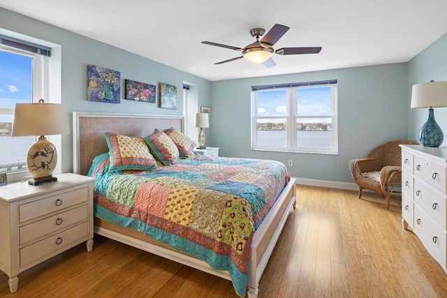 bedroom with light wood-type flooring and ceiling fan