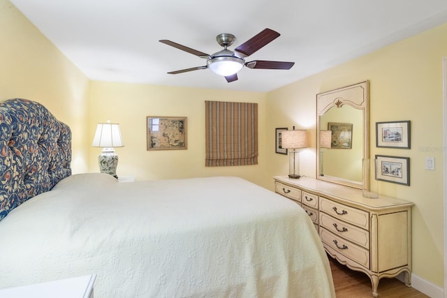 bedroom with ceiling fan and wood-type flooring