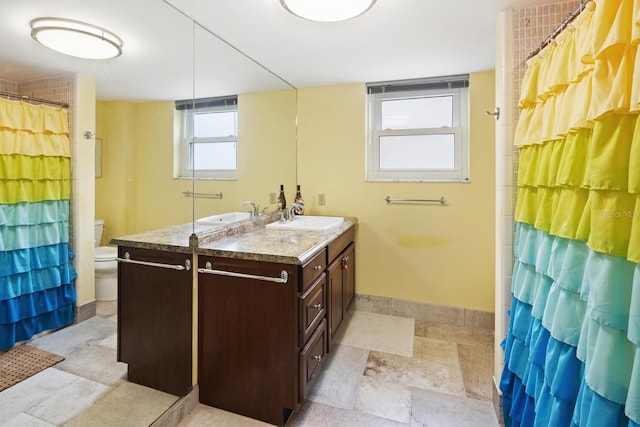 bathroom featuring vanity, toilet, and curtained shower