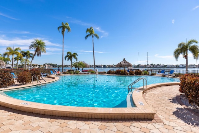 view of swimming pool featuring a water view