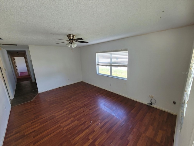 707 13th St W, Palmetto, FL 34221 - empty room featuring baseboards, a textured ceiling, wood finished floors, and a ceiling fan