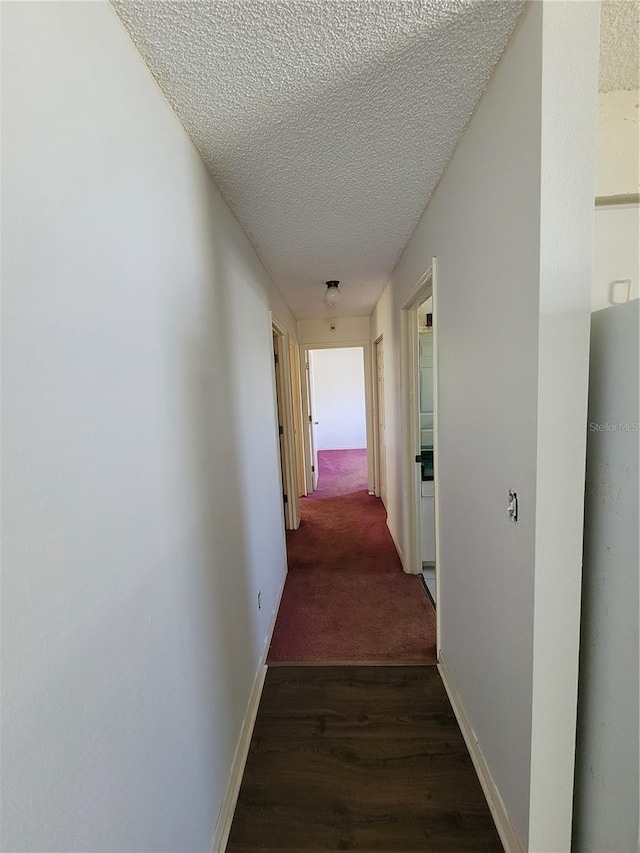 707 13th St W, Palmetto, FL 34221 - corridor with wood finished floors, baseboards, and a textured ceiling