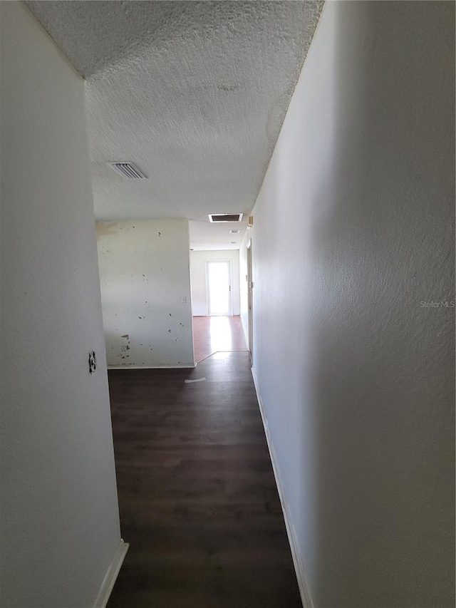 707 13th St W, Palmetto, FL 34221 - hall featuring baseboards, wood finished floors, visible vents, and a textured ceiling