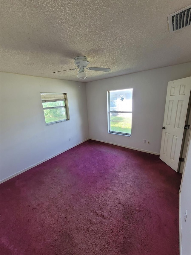 707 13th St W, Palmetto, FL 34221 - carpeted spare room featuring a textured ceiling, a ceiling fan, visible vents, and baseboards