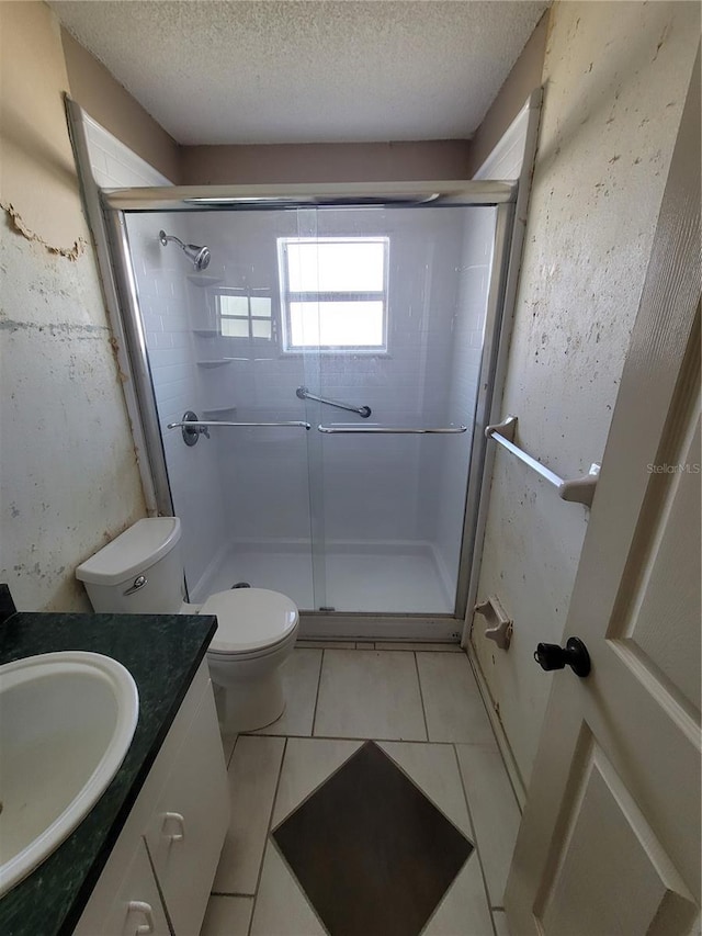 707 13th St W, Palmetto, FL 34221 - full bathroom featuring a textured ceiling, a shower stall, vanity, and tile patterned flooring