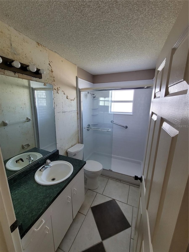 707 13th St W, Palmetto, FL 34221 - bathroom featuring vanity, a stall shower, tile patterned flooring, a textured ceiling, and toilet
