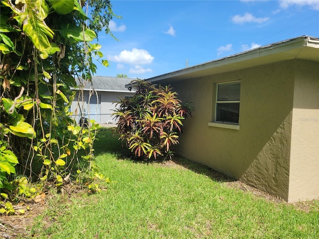 707 13th St W, Palmetto, FL 34221 - view of property exterior featuring a yard, fence, and stucco siding