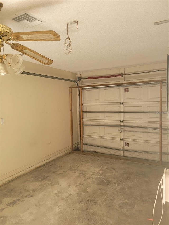 707 13th St W, Palmetto, FL 34221 - garage featuring baseboards, visible vents, and ceiling fan