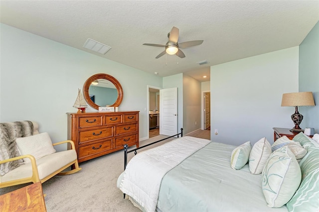 carpeted bedroom featuring a textured ceiling and ceiling fan