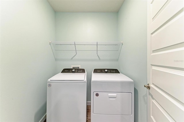 clothes washing area with separate washer and dryer