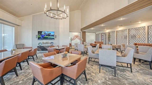 dining room with an inviting chandelier and high vaulted ceiling