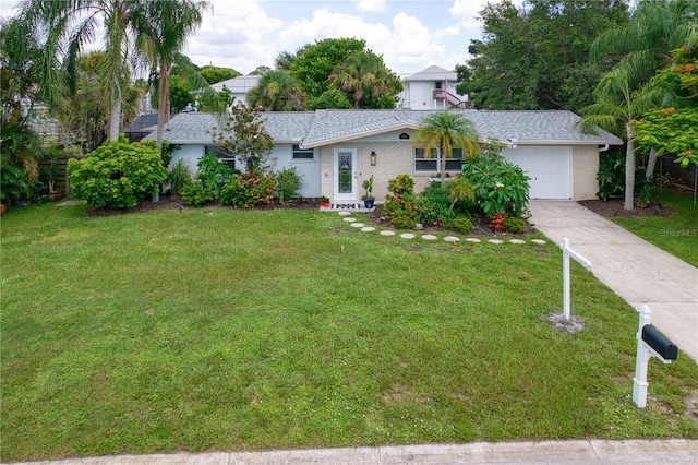 ranch-style home with a garage and a front lawn