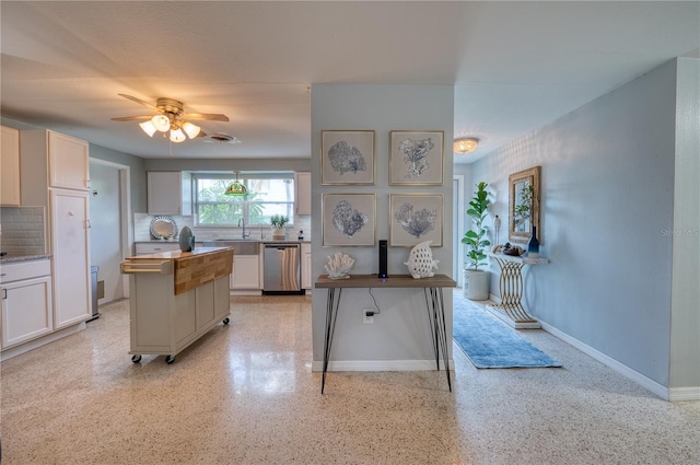 kitchen featuring tasteful backsplash, sink, a center island, dishwasher, and ceiling fan