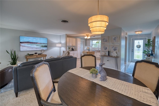 tiled dining space with ceiling fan