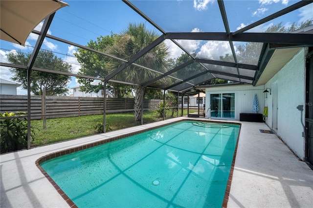 view of swimming pool featuring a patio and glass enclosure