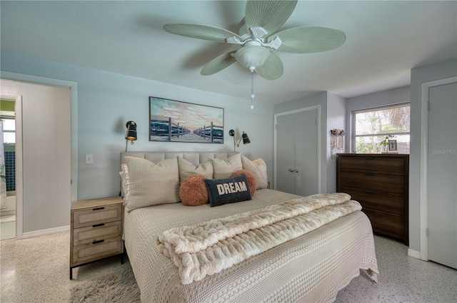 bedroom featuring ensuite bath and ceiling fan