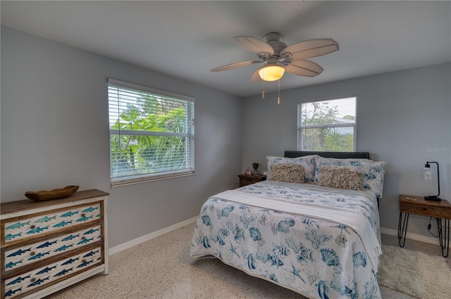 bedroom with multiple windows and ceiling fan