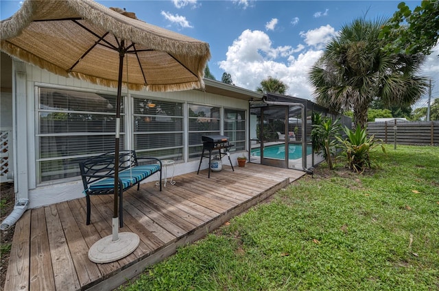 wooden terrace featuring a yard and a fenced in pool