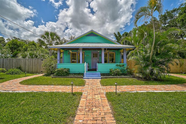 bungalow featuring a porch and a front yard