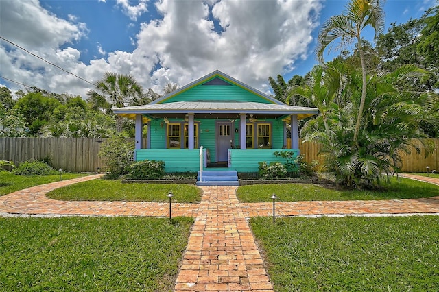 bungalow featuring a front lawn and covered porch