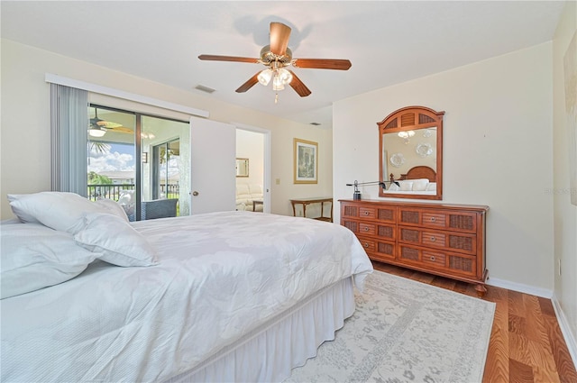 bedroom with wood-type flooring, access to outside, and ceiling fan