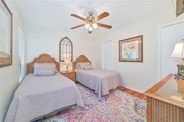 bedroom featuring ceiling fan, hardwood / wood-style floors, and a closet