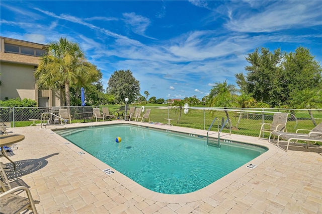 view of swimming pool with a patio