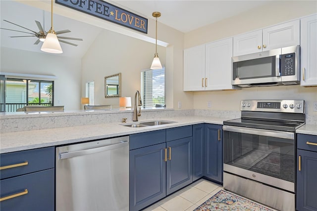 kitchen with sink, blue cabinetry, white cabinets, and appliances with stainless steel finishes